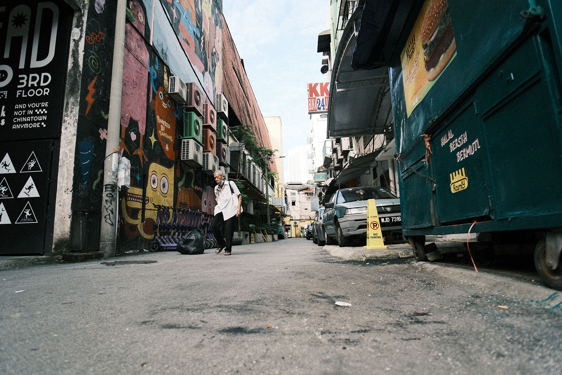 Camera Shutter Speed Guide - A elderly man walking on the alley street in Kuala Lumpur