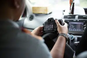 ISO Camera Settings Guide - Man in the car holding a camera