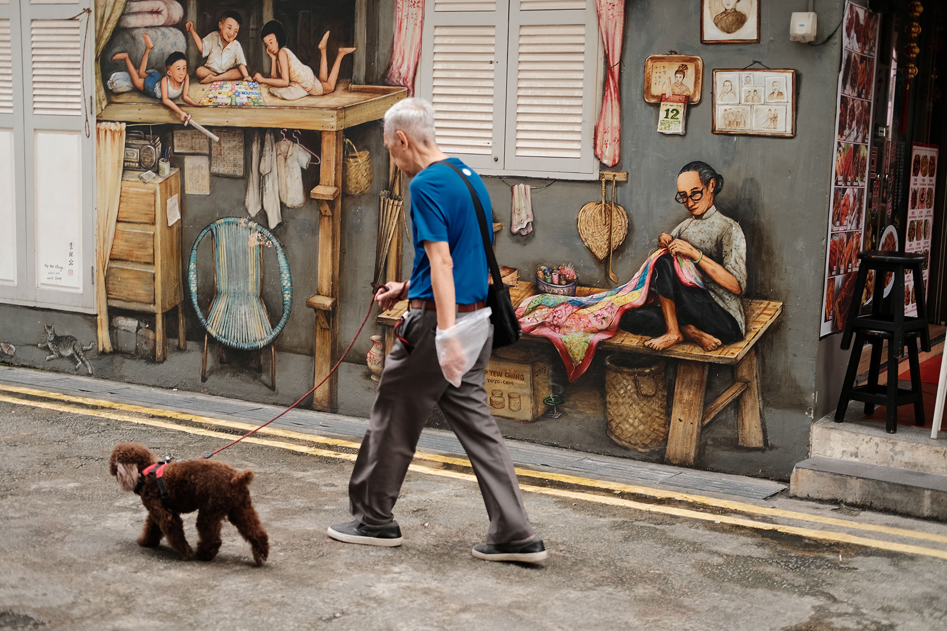 Street Photography Camera Aperture Guide - Elderly man walking in the wall art alley in Singapore